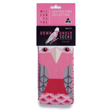 Pair of long pink galah socks being worn against a white background.