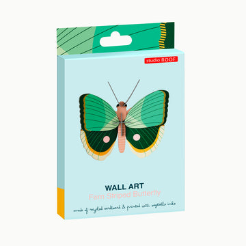 Butterfly-shaped carboard model with green and brown wings on a white background.