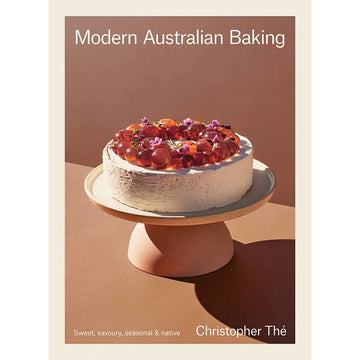 Book cover of 'Modern Australian Baking' with a cake on a stand against a brown background.