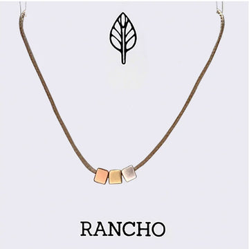 Necklace with geometric cube pendants on a light gray background, featuring the brand 'RANCHO'.