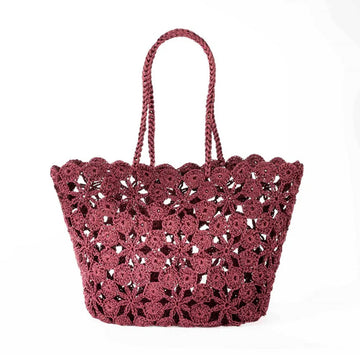 Burgundy coloured crochet handbag on a white background.