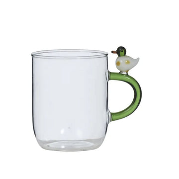 Clear glass mug with a green handle featuring a duck design on a white background.