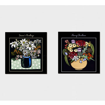 Pack of Christmas cards with floral design on a black background.