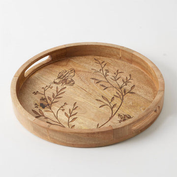 A wooden tray with cut out handles and an etch design of a bee and leaves.