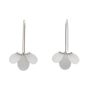 A pair of earrings in silver featuring a three petal shaped design with the top two petals flipped over.