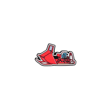 Red snowmobile metal magnet on a white background.