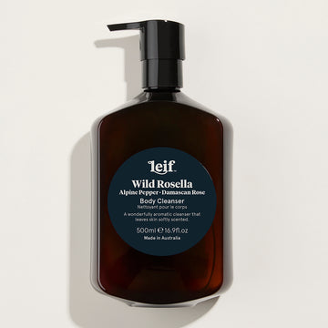A clear pump bottle filled with a brown liquid and the text 'Wild Rosella Body Cleanser' written on a round label.
