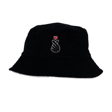 Black bucket hat with an embroidered  hand and heart design on a white background.