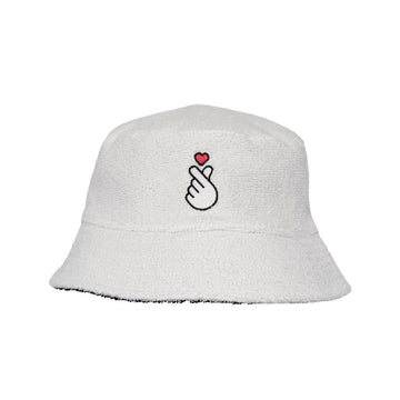 Black bucket hat with an embroidered  hand and heart design on a white background.