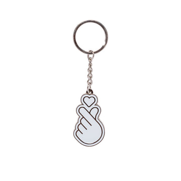 Keychain with a design of a hand holding a heart on a white background.