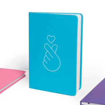Blue notebook with a white outline of a hand and heart on a white background.