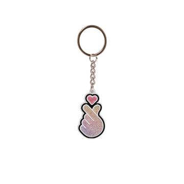 Keychain with a heart and hand design on a white background.