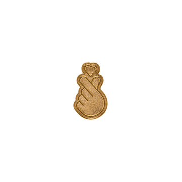 Gold-colored pin with a hand and heart design on a white background.