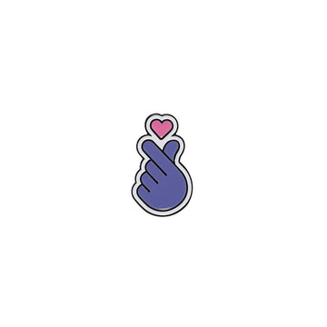 A purple and pink pin shaped like a hand making a heart symbol.