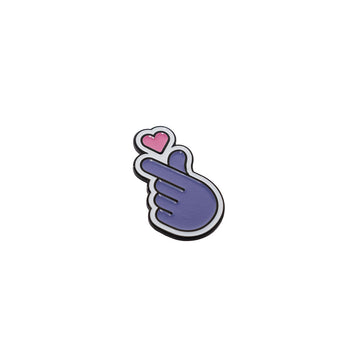 A purple and pink pin shaped like a hand making a heart symbol.