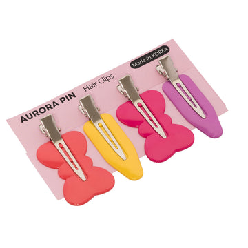 Set of colorful bow-shaped hair clips on a pink card with 'Aurora Pin' branding.