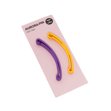 Two purple and yellow hair clips on a pink card with 'Aurora Pin' branding.