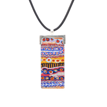 A rectangle shaped pendant printed with artwork by Murdie Morris on a black cord.