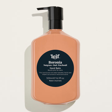 A brown pump bottle with a black lid and a dark blue circle in the middle with product information.