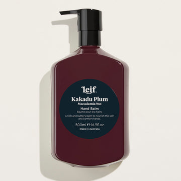A large pump bottle in brown with a dark blue round product label on the front titled 'Kakadu Plum Hand Balm'.