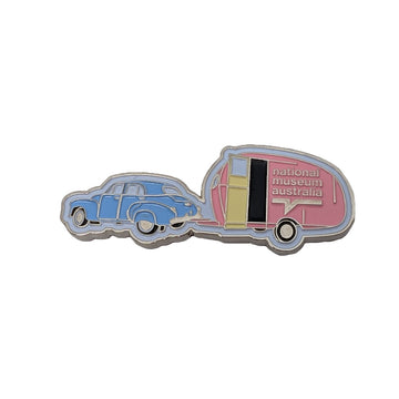 Enamel magnet shaped like an FJ Holden and pink caravan.