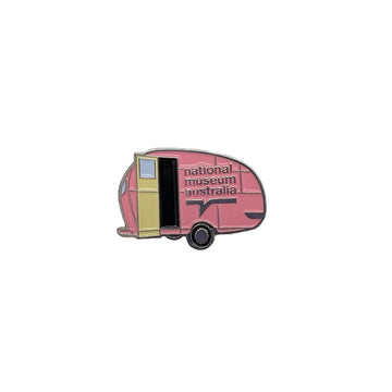 Pink caravan enamel pin with 'National Museum Australia' text on a white background.