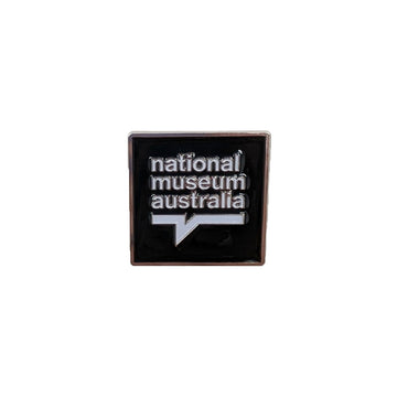 Enamel square pin with 'National Museum Australia' text on a white background.
