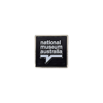 National Museum Australia logo on a black background on a square enamel magnet.