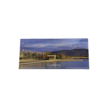 Fridge magnet with a scenic view of Canberra, Australia, featuring a lake and mountains.