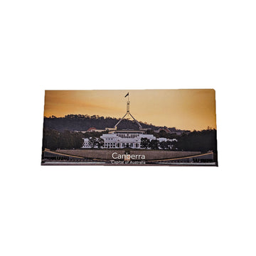 Souvenir magnet with a sunset view of the Parliament House in Canberra, Australia.