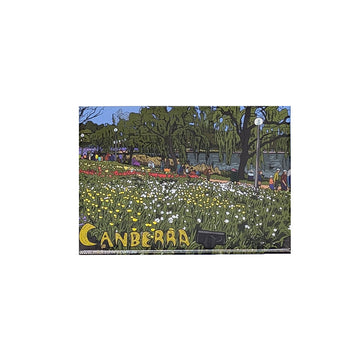 Rectangle magnet with a scenic view of a Floriade in Canberra, featuring trees and people.