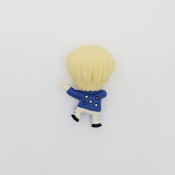 Small figurine of a character with blonde hair and a blue outfit on a white background.