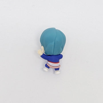 Small figurine of a character with blue hair and outfit on a white background.