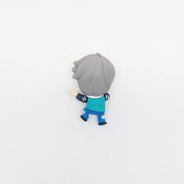 Character figurine with gray hair and blue outfit on a light gray background.