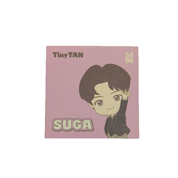 Square product packaging with a cartoon character and 'TinyTAN' branding on a pink background.
