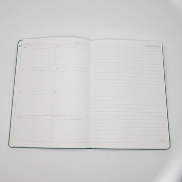 Green notebook with cartoon character and text on a white background.
