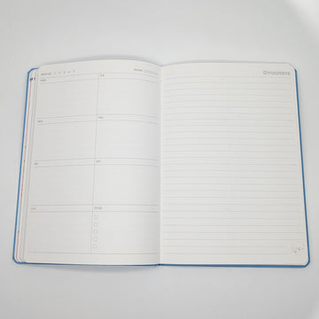 Blue notebook with a cartoon character and text on a white background.