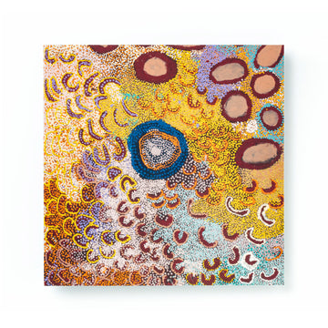 A square greeting card printed with Indigenous artwork of arches, circles and dots.