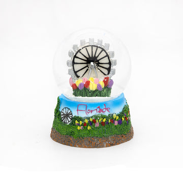 A snowglobe with a ferris wheel and tulips inside with the text 'Floriade' with more tulips along the base.