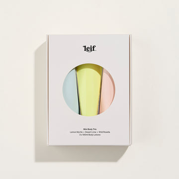 A white box with a circle cut out showing three pastel coloured tubes inside.