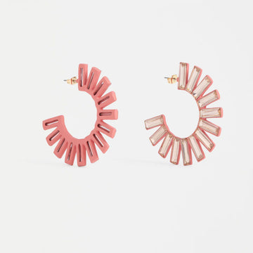 Pair of pink hoop earrings on a light gray background.