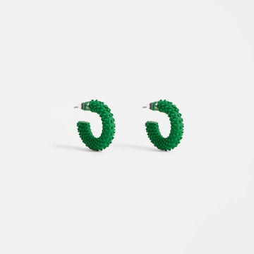 Green hoop earrings on a white background.