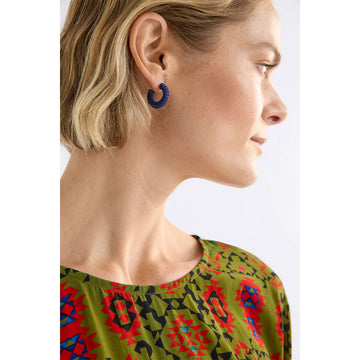 Purple hoop earrings on a white background.