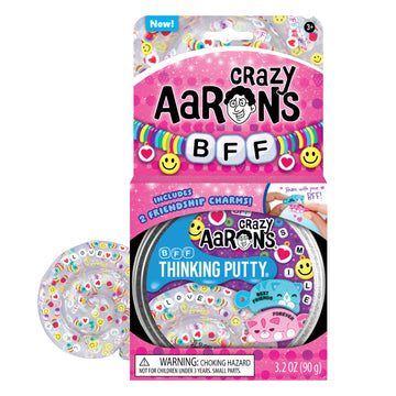 An open card packaging with the heading 'Crazy Aarons BFF' with a tub of putty visible. There is some putty next to the box with friendship bracelets charms visible inside.