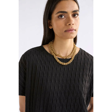 Gold necklace on a white background.