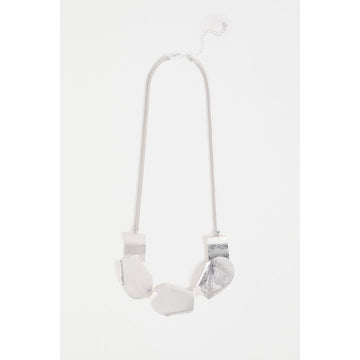 A silver necklace with five overlapping shapes as the long pendant.