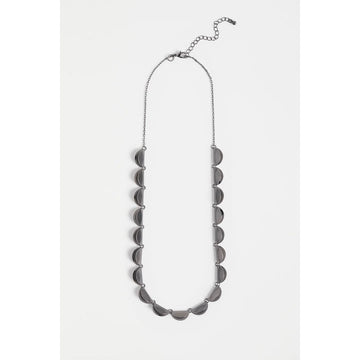 Silver necklace with scalloped edge on a white background.