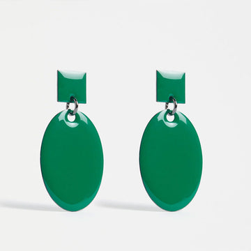An image of a pair of earrings in a Milan Green coloured enamel finish with a large oval drop of a square stud.