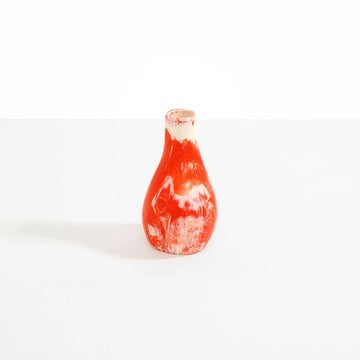 A resin vase in orange pink.