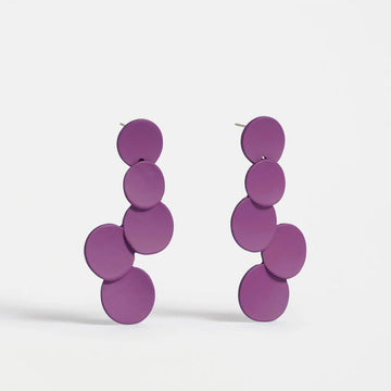 Pair of purple circular earrings on a white background.